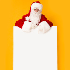 Santa Claus with big white promo poster on bright orange