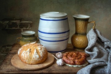 Rural still life with bread and baking sausage