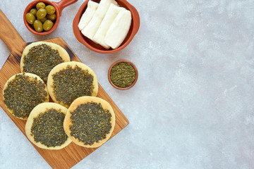 Zaatar manakeesh with olives and white cheese. Top view with space for text	
