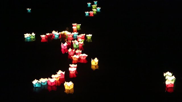 Glowing lanterns floating on the river  in the Hoi An  city, Vietnam