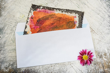 Envelope of white color- wooden background