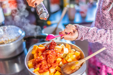 Home chef adding a spoonful of tomato puree to make a nutritious and healthy homecooked vegetarian...