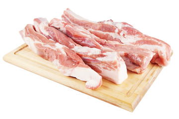 Fototapeta premium Several pieces of fresh pork on a wooden cutting board
