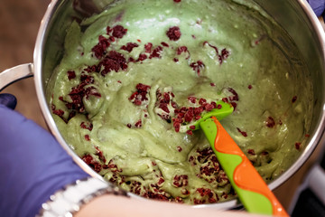 Pistachio dough pastry with raspberries for muffins. Baking in cafe.