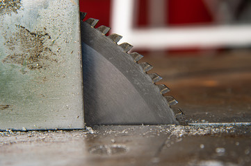 Closeup metal circular saw blade with blurred background.