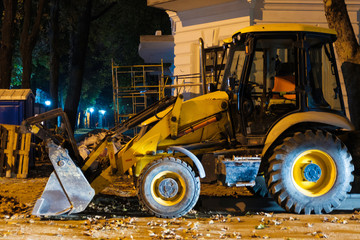 Big yellow construction bulldozer at night