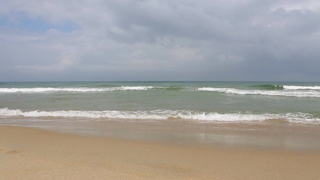 Pacific Ocean waves on the beach in the town of Hoi An, Vietnam