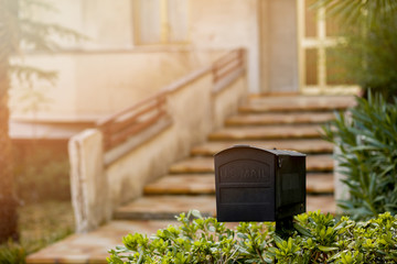 Metal mail box in front of a house