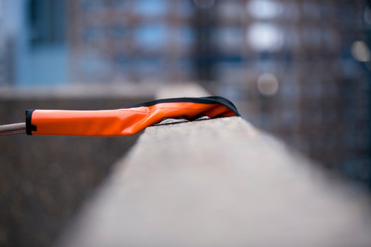Using industry heavy duty orange safety rope protection to protecting damaging from sharp edge corner with blurry building at the back ground construction  site Sydney city CBD, Australia    
