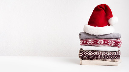 Winter holiday knitted sweaters in Santa's hat on white