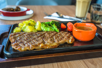 tenderloin steak with french fries and vegetables