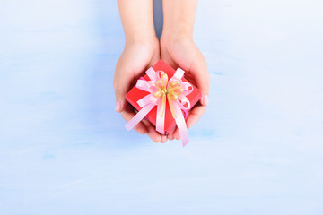 Woman hand holding gift box for giving in special day
