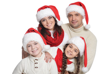 Close up portrait of family with kids in santa hats