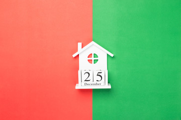 Fototapeta na wymiar Wooden cubes calendar 25 December on red and green
