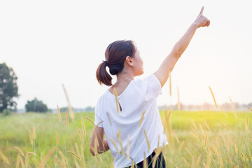 Young woman raise hands up for her success, Concept of Success in life.