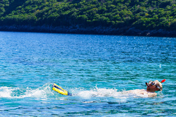 Man with snorkeling tube in sea