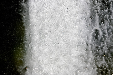 crystals of liquid on glass. frozen water. space concept from snowflakes