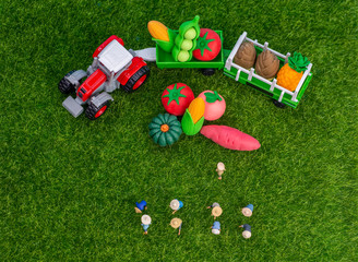 Miniature toys studio set up - Top view of manual labourers picking fresh produce or planting...