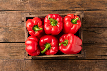 Overhead shot of red bell pepper in box on vintage wooden table with copyspace. Sweet paprika - Powered by Adobe