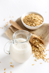 Obraz na płótnie Canvas Oat milk. Healthy vegan non-dairy organic drink with flakes