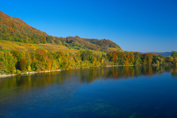 The river Rhine, only a few hundred meters young, after leaving Lake Constance. Autumn. Near the Swiss town Stein am Rhein. View from the car bridge to the west, the road leads to the Rhine Falls.