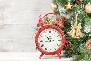 Christmas card with decorated fir tree and clock