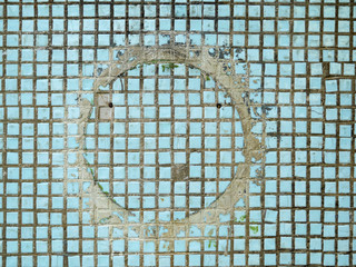 White mosaic grungy background with circle in the middle.