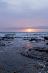 Sunlight through the cloud in a rocky coastline.