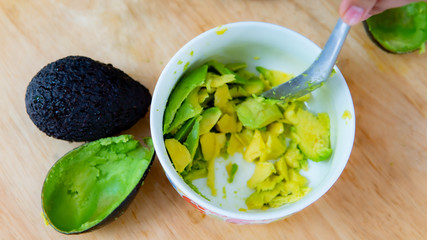 Close up hand cooking avocado in the kitchen