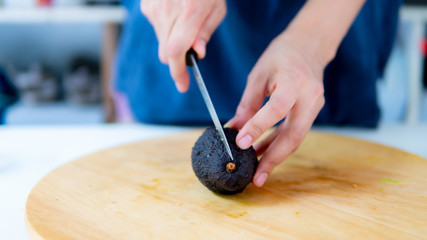 Close up hand chef cutting avocado fruit