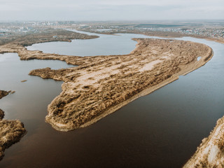 Elongated island on the autumn river. Flood. Flooded areas of the river. The view from the top.