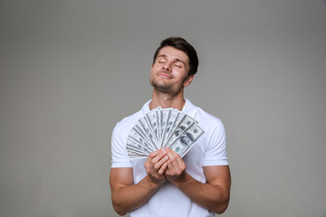 Dreaming man posing isolated over grey wall