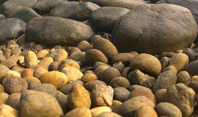 Fototapeta na wymiar Rock and pebbles on the beach