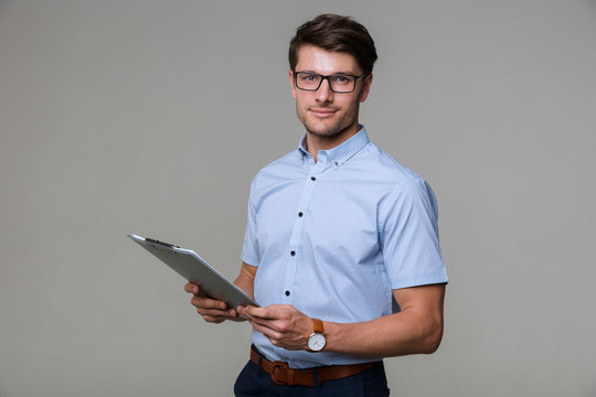 Man Posing Isolated Over Grey Wall Background