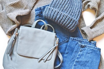 Modern youth fashionable clothes. Autumn and winter season outfit. Gray sweater, blue jeans,...