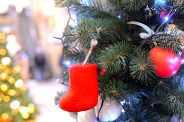 Little red felt boots and Chtistmas balls on Christmas tree