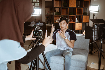 young man blogger recording vlog talking to camera when work at home