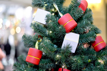 White and red Christmas gift boxes on Christmas tree