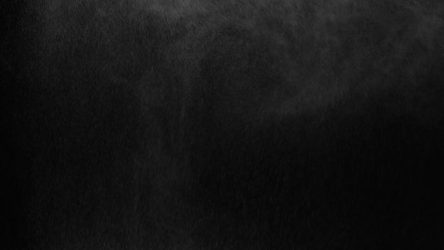 white vapour or spray water on a black background ,slow motion movement