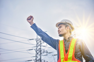 Engineer Holding Hand Success against Sky high Voltage tower background