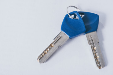top view of two house keys on white surface