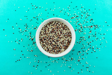quinoa in bowl on green background.