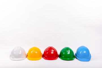Many colorful hard hats side by side