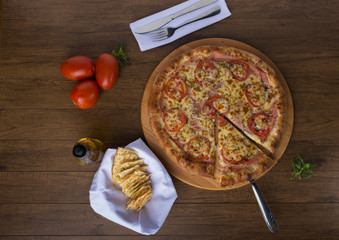 Paulista flavored pizza on wooden board made with pasta, sliced ​​tomatoes, mozzarella cheese,...