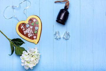 Blue wooden background with heart bell and glasses
