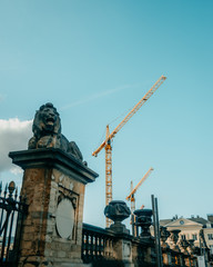 There are two cranes behind the fence