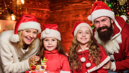 Family tradition. Bearded man and mother with cute daughters christmas eve. Parents and children excited about christmas. Happy holidays. Spend time with your family. Friendly family winter vacation