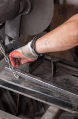 Cutting metal with grinder in workshop. Sparks while grinding iron. Cutting machine.