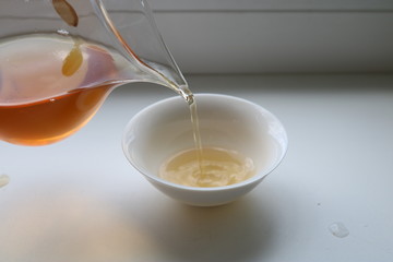 Chinese tea ceremony using tea utensils made of glass, clay and porcelain.