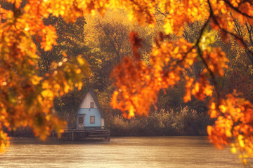 Naklejka na ściany i meble Wooden house in autumn nature